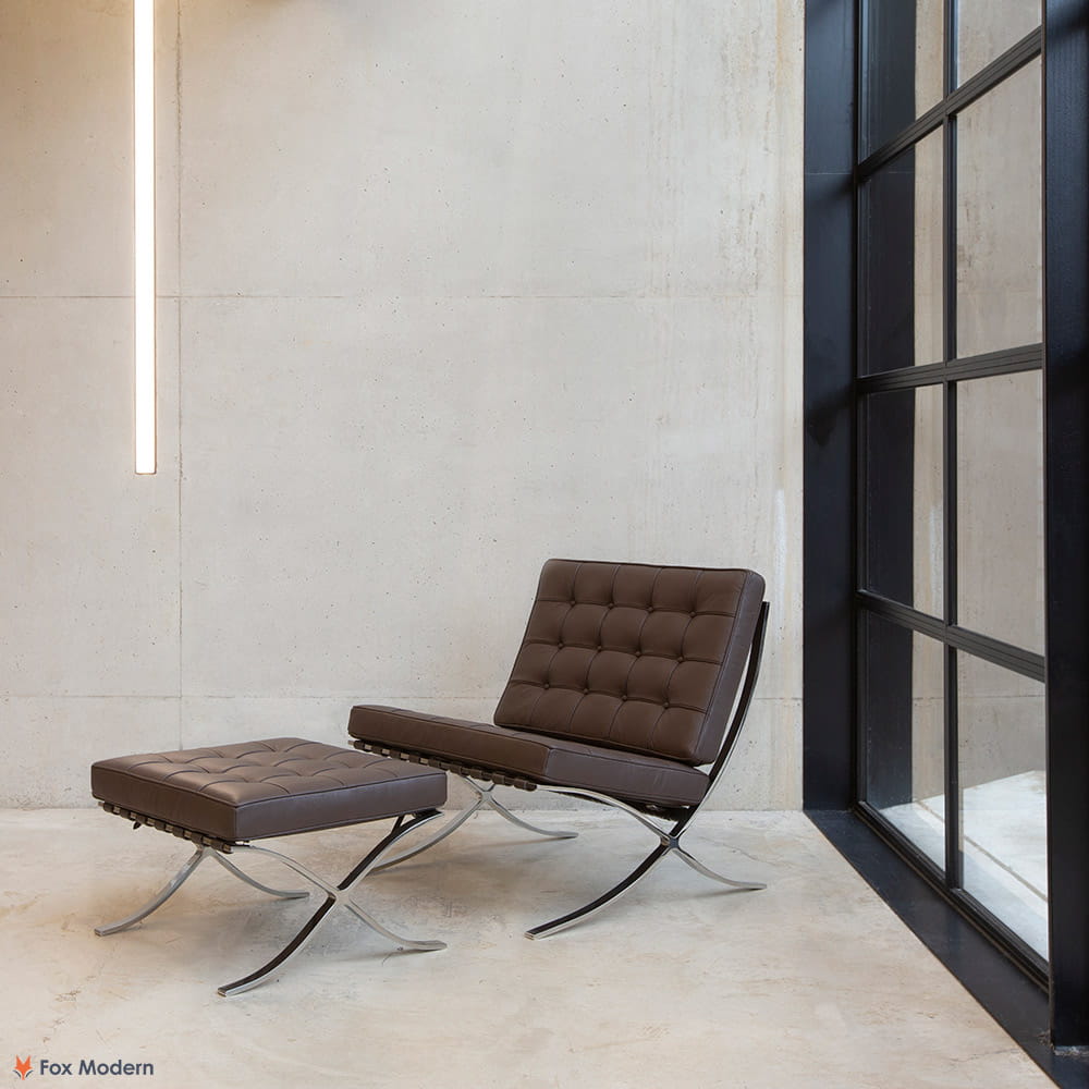 Angled view of brown leather Barcelona Pavilion Chair and Ottoman shown in a living space