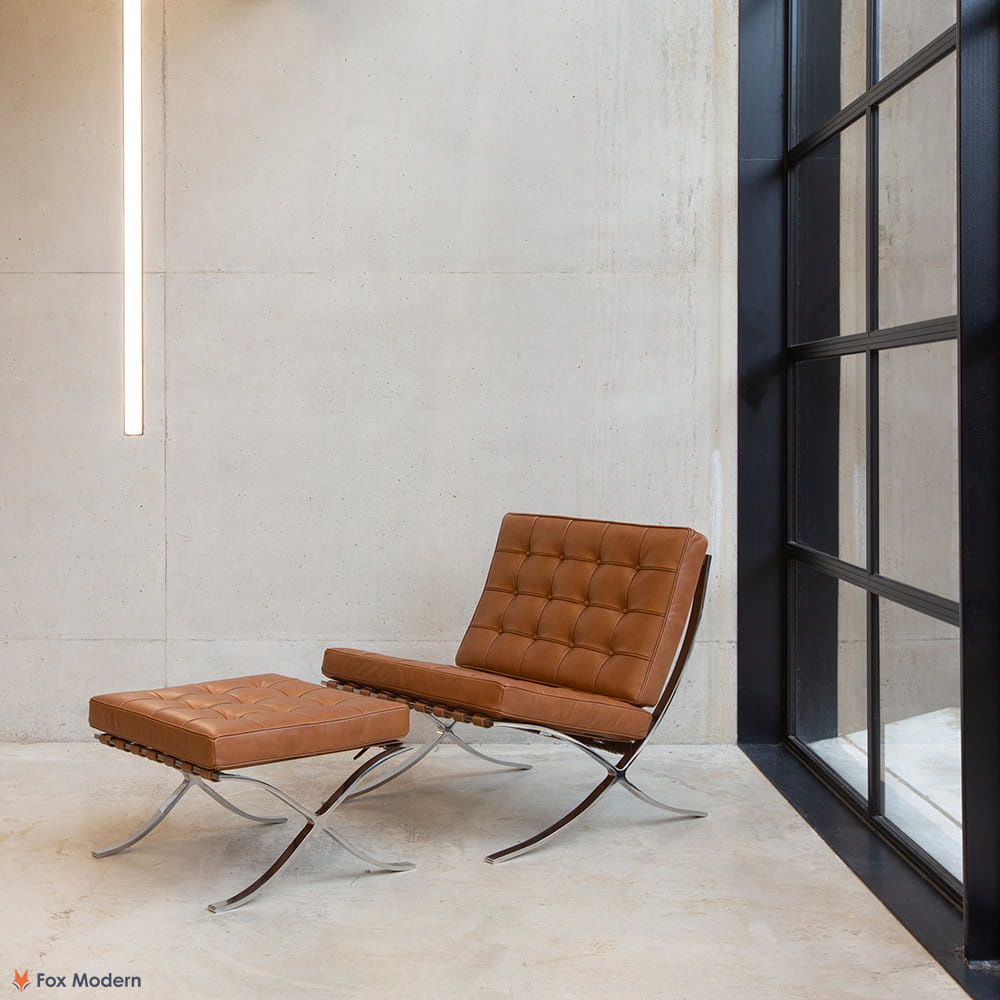 Angled view of tan leather Barcelona Pavilion Chair and Ottoman shown in a living space
