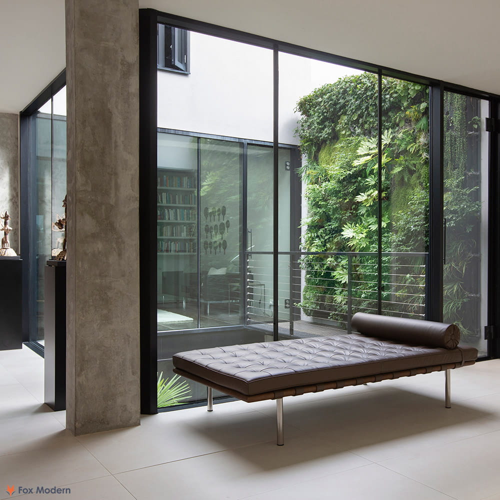 Angled view of brown leather Barcelona Pavilion Daybed shown in a living space