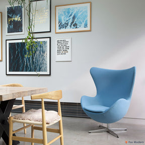 Angled front view of blue fabric Arne Jacobsen egg chair shown in a living space