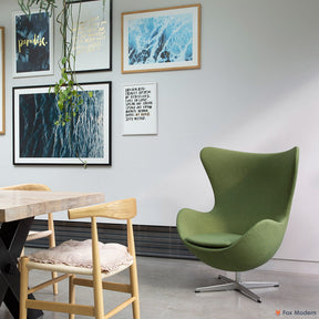 Angled front view of green fabric Arne Jacobsen egg chair shown in a living space