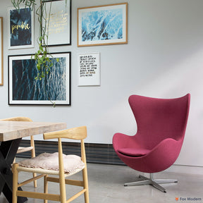 Angled front view of pink fabric Arne Jacobsen egg chair shown in a living space