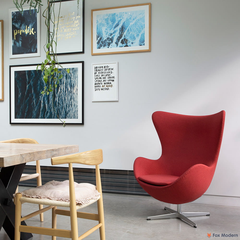 Angled front view of red fabric Arne Jacobsen egg chair shown in a living space