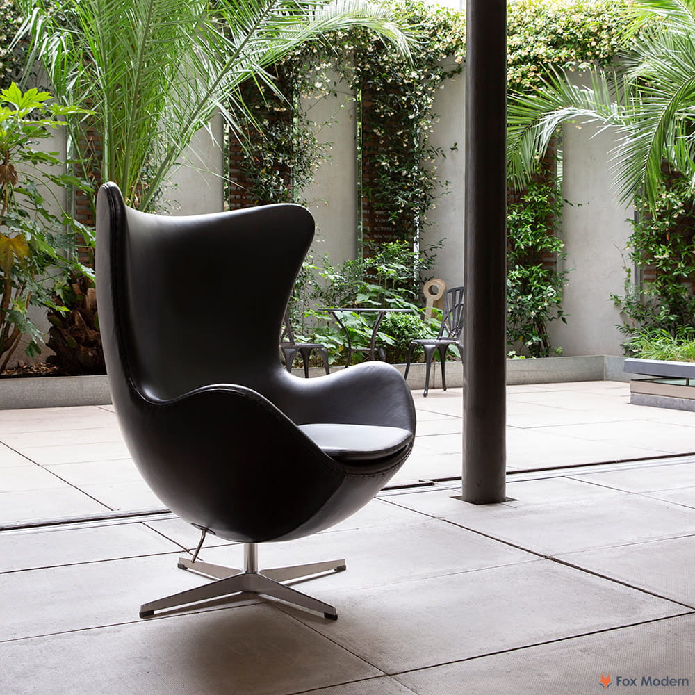 Angled view of black Arne Jacobsen Egg Chair shown in a living space