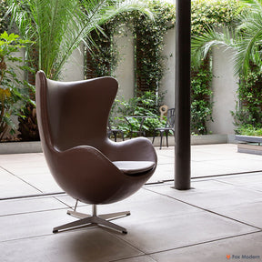 Angled view of brown Arne Jacobsen Egg Chair shown in a living space