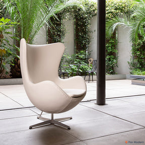 Angled view of white Arne Jacobsen Egg Chair shown in a living space