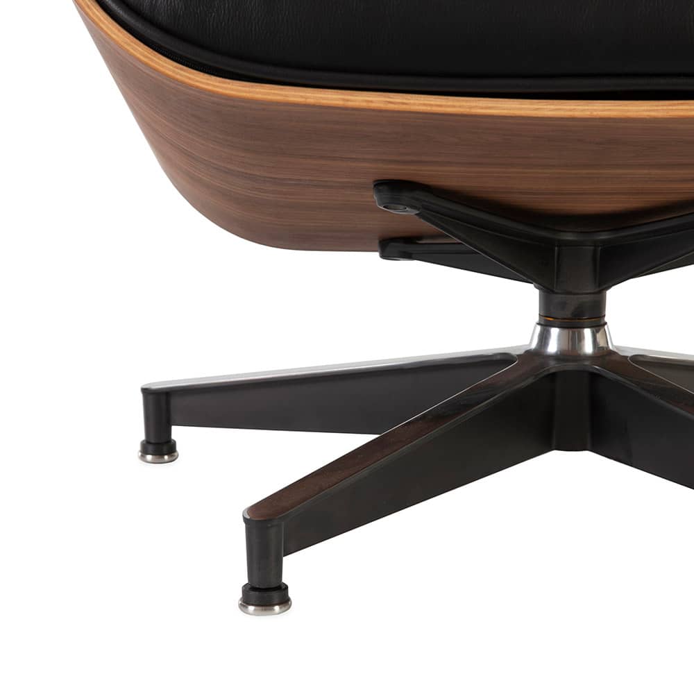 View of the black base of the black and walnut Eames Lounge Chair & Ottoman on a white background