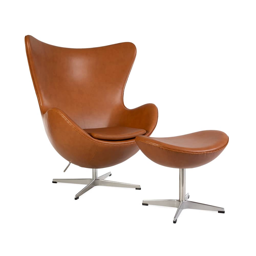 Angled front view of the tan leather Jacobsen Egg Chair & Ottoman Set on a white background