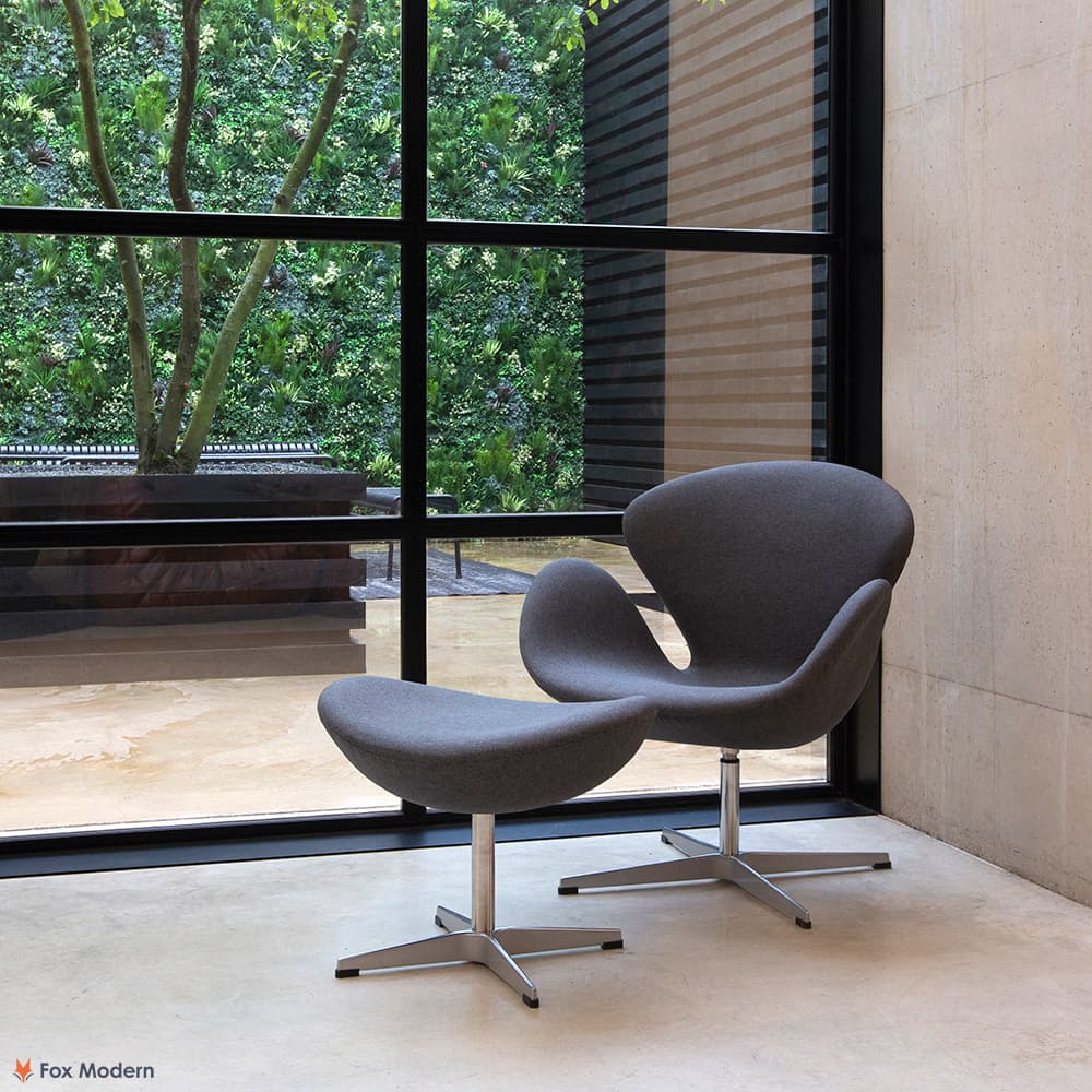 Angled view of grey fabric Jacobsen Swan Chair & Ottoman shown in a living space