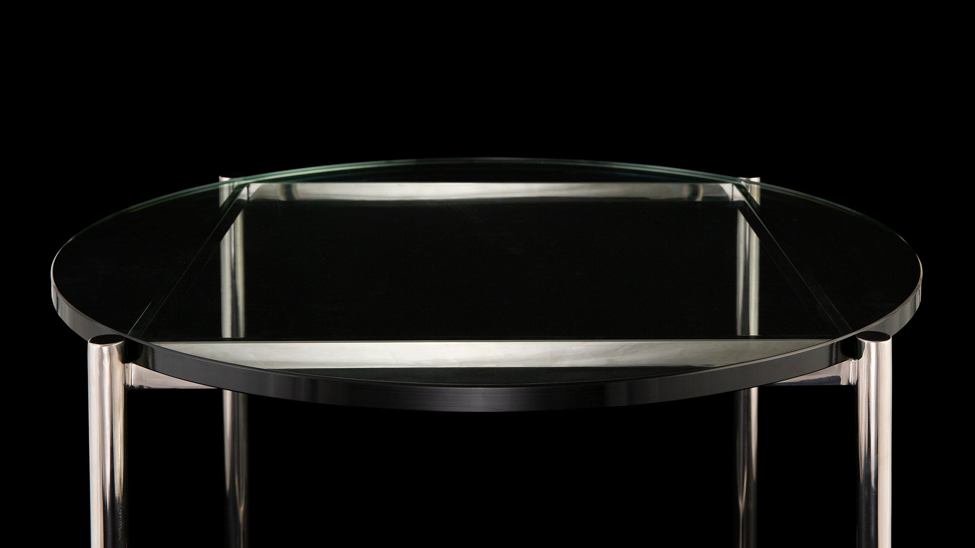Top angled view of the Barcelona Occasional table on a black background