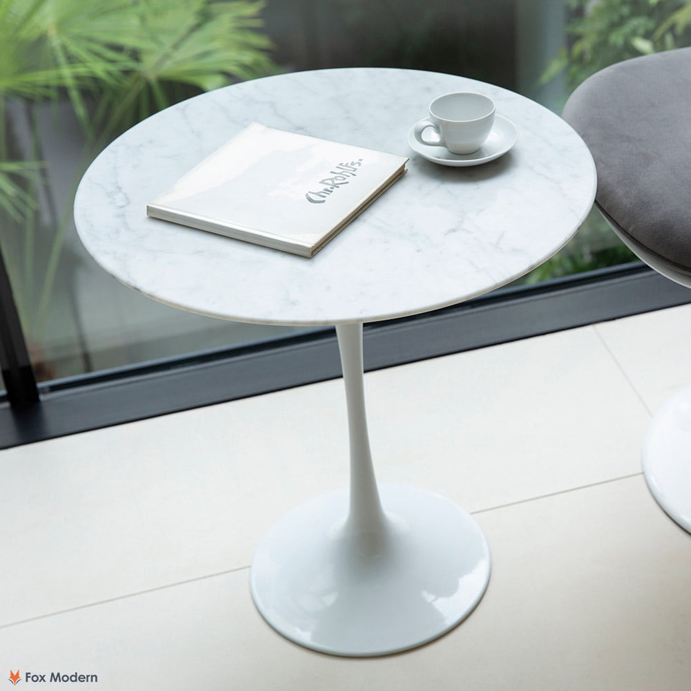 Angled top view of white Carrara marble Saarinen Tulip Side Table shown in a living space