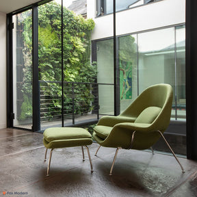 Front angled view of green fabric Saarinen Womb Chair & Ottoman shown in a living space