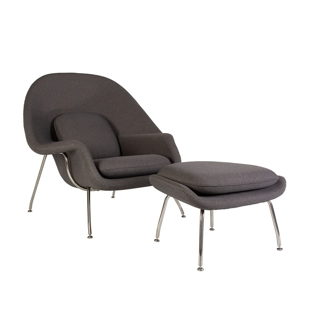 Angled front view of the grey fabric Saarinen Womb Chair and Ottoman on a white background
