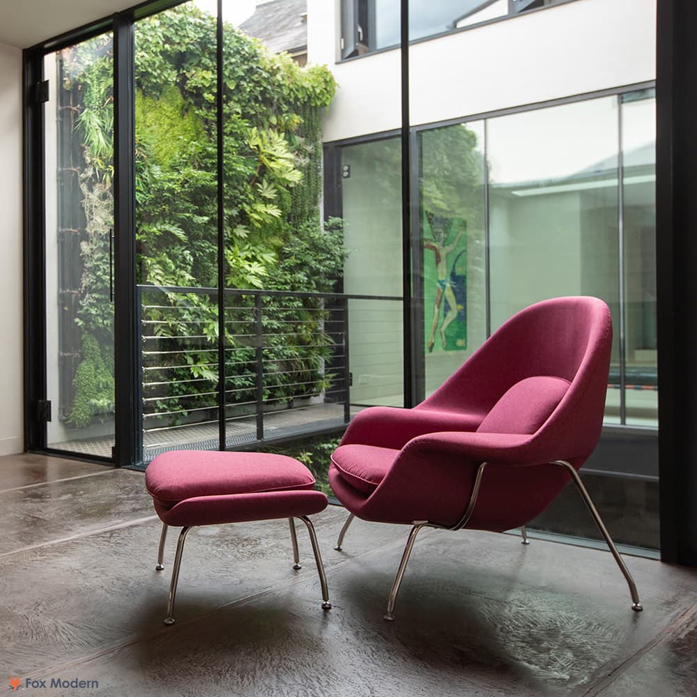 Front angled view of pink fabric Saarinen Womb Chair & Ottoman shown in a living space