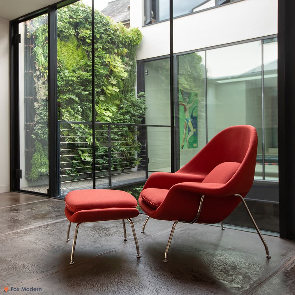 Front angled view of red fabric Saarinen Womb Chair & Ottoman shown in a living space