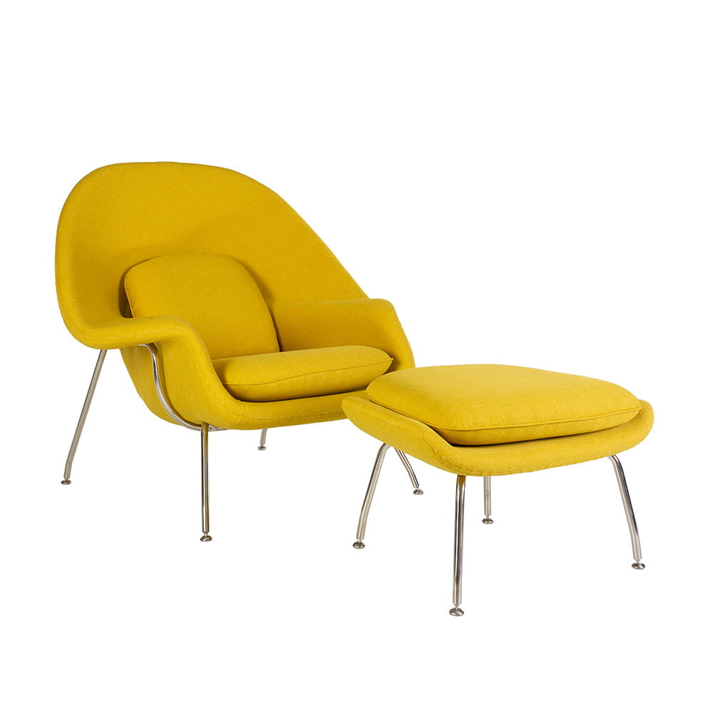 Angled front view of the yellow fabric Saarinen Womb Chair and Ottoman on a white background