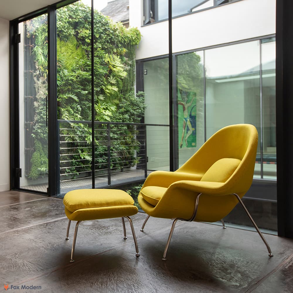 Front angled view of yellow fabric Saarinen Womb Chair & Ottoman shown in a living space