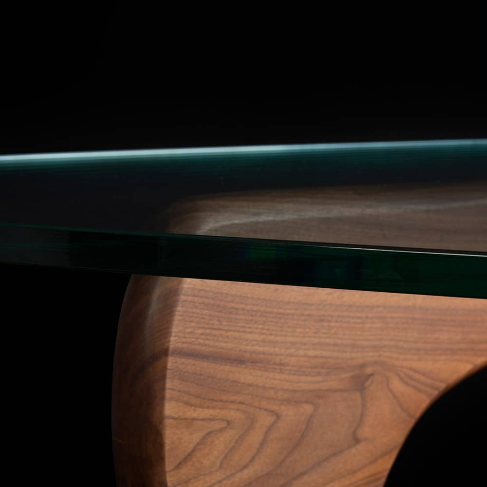 Close up artistic view of walnut Noguchi Coffee Table on black background