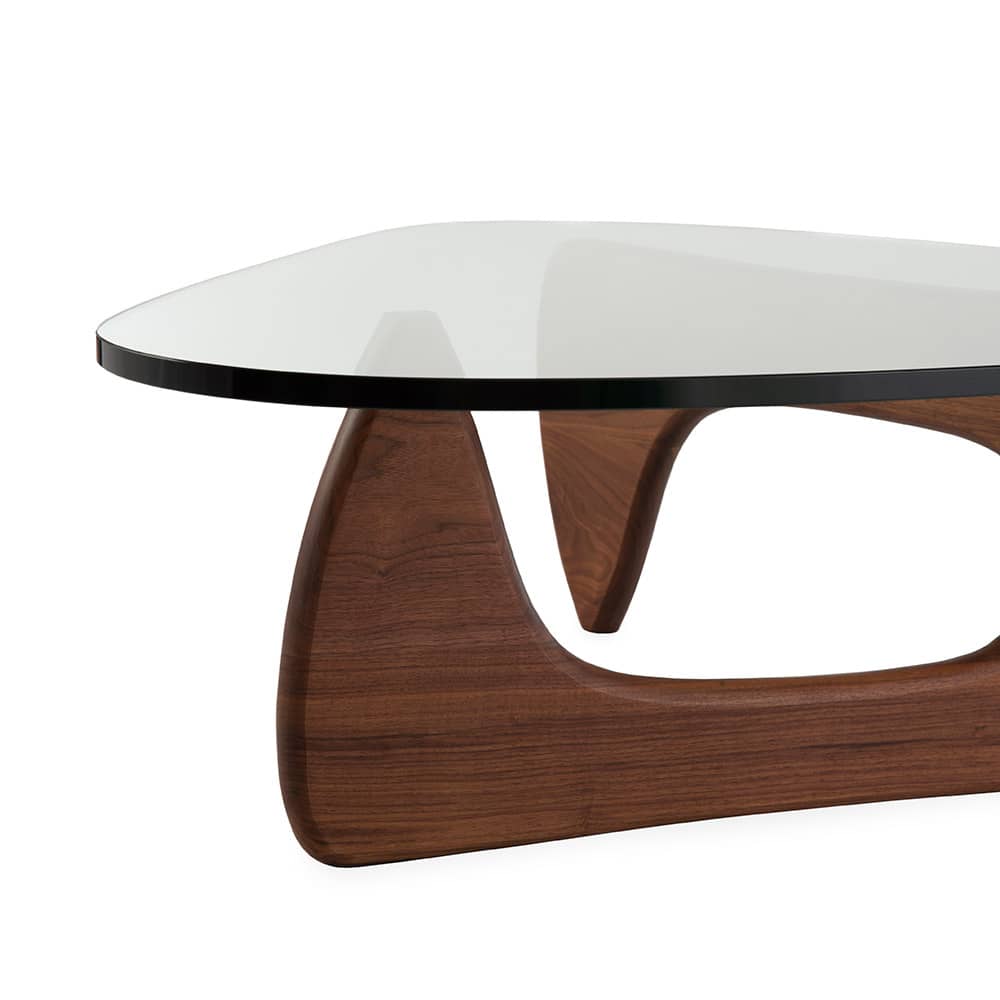Partial front view of walnut Isamu Noguchi Coffee Table on a white background